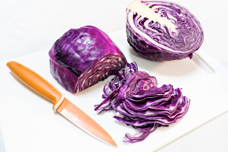 Cut red cabbage isolated on whiteの写真素材