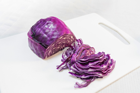 Cut red cabbage isolated on whiteの写真素材