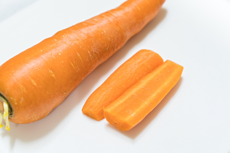 Sliced carrots with knife isolated on white backgroundの写真素材