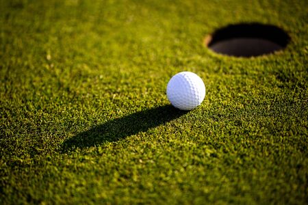 Closeup of golf ball on the grass, ready for playing professional golfの写真素材