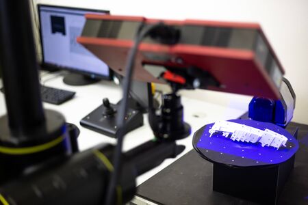Professional 3D scanner scanning an industrial object, plastic molding placed on a turntable