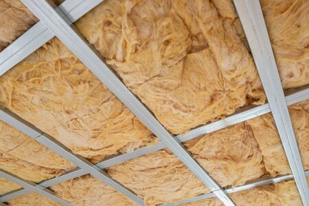 Glass wool on the roof of the new house, ready for plasterboard, industrial conceptの写真素材