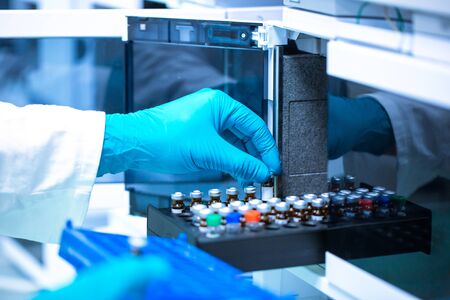 Pharmacist, scientist inserts some samples for chromatographic testingの写真素材
