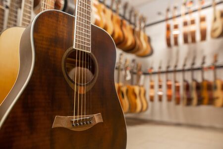 Close up of modern, wood guitar, view to instrument shop, music instrumental conceptの写真素材