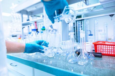 Professional female chemist researcher carrying out scientific research in a labの写真素材