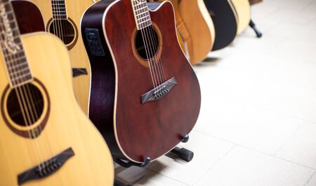 Close up of wooden guitar in a row in instrument shop