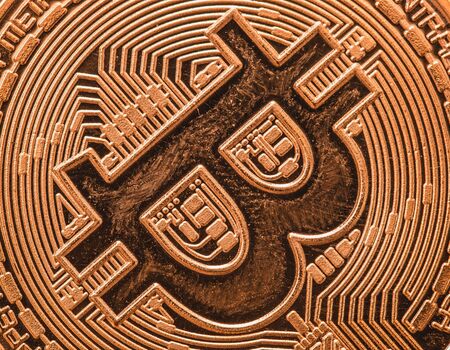 Close up of failing cryptocurrency sign bitcoin coin, finance and stock exchange concept, macro...