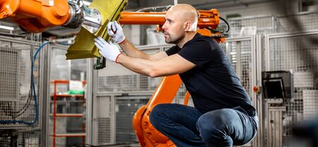 Engineer repairing an automatic robot amrs in automotive, smart factory, industrial concept
