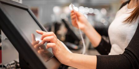 Close up of saleswoman hands accounting, billing some goods for sale, finance conceptの写真素材