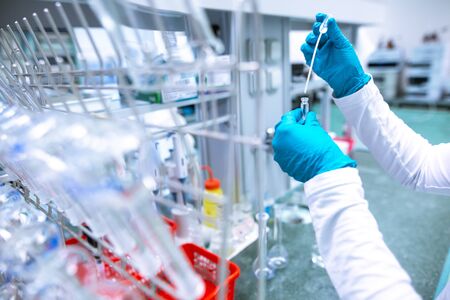 Laboratory scientist conducting a research, experiments, chemist adjusts samples in a petri dish,...