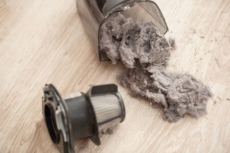 Close up of massively clogged, dirty filter of hand vacuum cleaner, dust and powder on the vacuum filter, householdの写真素材