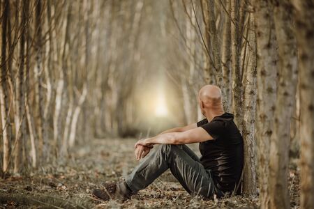 Sitting man with depression going through a rough patch in his life, suffering from mental...