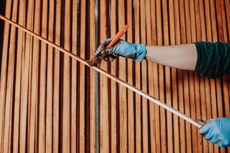 DIY concept, woman painting some pieces of wood for her new furniture, householdの写真素材