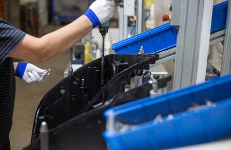 Production operator assembling frontlight headlamp, headlight for a vehicle or car in automotive...