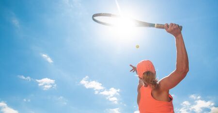 Professional tennis woman player in an action playing tennis in tennis court outdoor, sport concept, copyspaceの写真素材