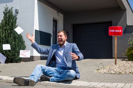 For sale real estate concept, man moving out of the house due to the economic crisis, impact of the...