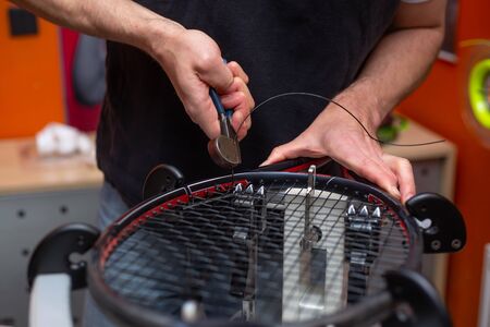 Process of stringing a tennis racket in a tennis shop, sport and leisure conceptの写真素材