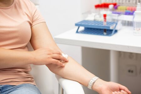 Woman after taking a blood from a vein, medical conceptの写真素材