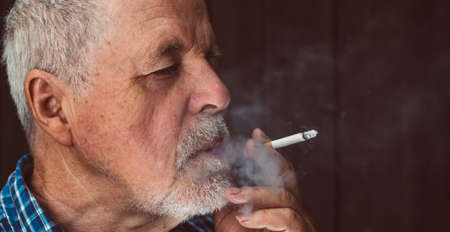 Senior man smoking cigarette outside, the cigarette addiction, unhealthy concept, bad habit