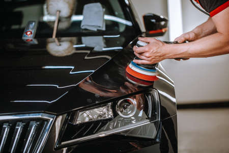 Professional detailing a car in car studio