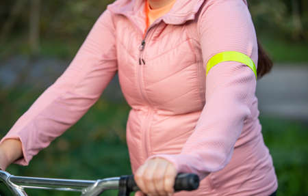 Close up of a detail to reflective yellow slap, tape or element clothing on the hands, transport safety conceptの写真素材