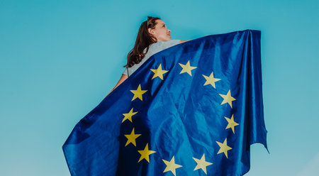 Pretty young woman promoting or showing EU, european union flag, feel free brexit