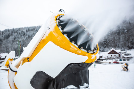 Snow cannon, machine or gun snowing the slopes or mountain for skiers ans snowboarders, artificial snowの写真素材
