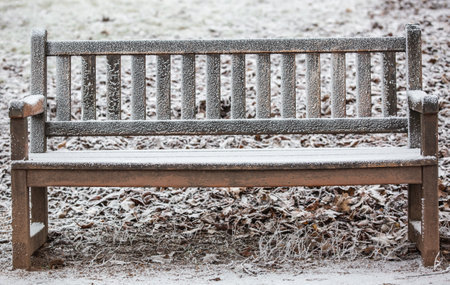 Close up of a frozen wooden bench during lovely winter timeの写真素材