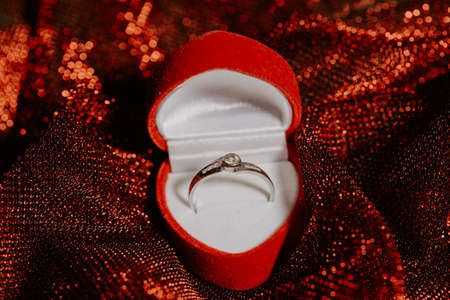 Close up of white gold engagement ring with a diamond, marriage proposal concept