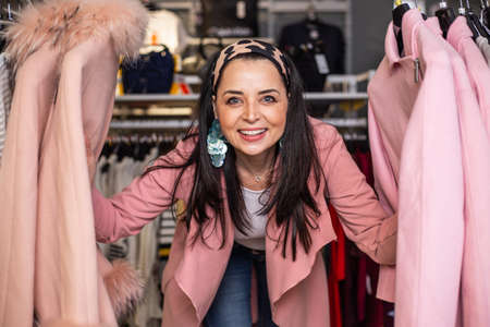 Pretty young woman enjoying and having fun with shopping at the shop store or boutique, portrait at a shopの写真素材