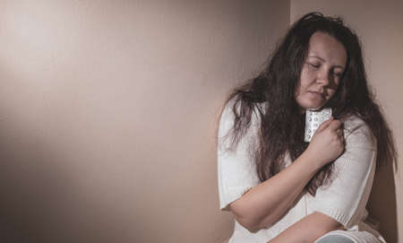 Young woman suffering from a severe depression and anxiety, psychiatric problem after covid-19の写真素材