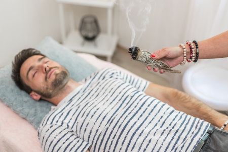 Woman healer doing aromatherapy by smoldering sage, an alternative medicineの写真素材
