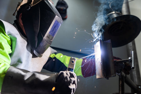 Industry worker welding a pieces of metal in the factory, weld concept