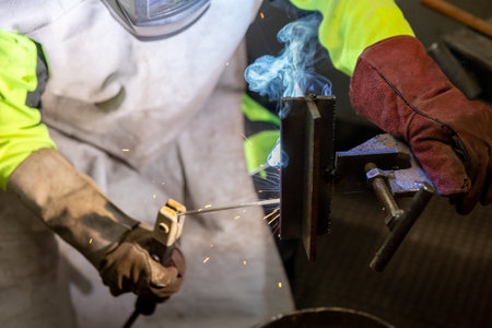 Industry worker welding a pieces of metal in the factory, weld concept