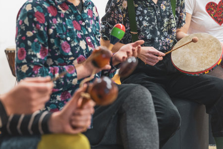 Group of people playing on different kinds of musical instruments during music therapyの写真素材