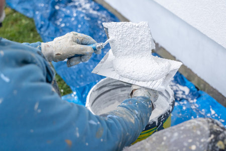 Worker applying plaster material with trowel for renovationの写真素材