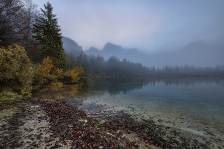 Early Morning Tranquility at Almsee Amidst Totes Gebirge Peaks in Salzkammergut, Austriaの写真素材