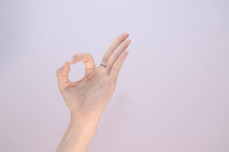 female making hand ok on white isolated, background Closeup of woman hand gesturing - showing sign okayの写真素材