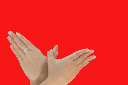 Female hands with ring on a red background. The concept of love.