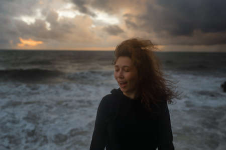 girl standing against the background of the stormの写真素材