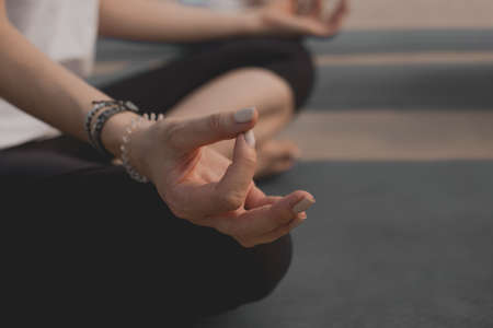 girl performing yoga meditation close up shot on hand and sitting position