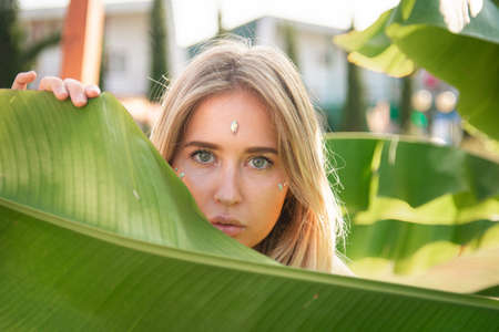 portrait of a beautiful girl in green leaves.