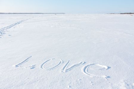 Love - is the inscription on the snowの写真素材