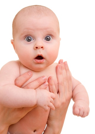 Surprised kid looks at a white background.の写真素材