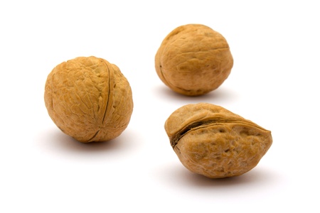 Three walnuts in bulk on a white background.の写真素材