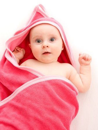 Surprised kid looks at a white background.の写真素材