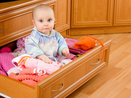 Baby was sitting in the closet.の写真素材