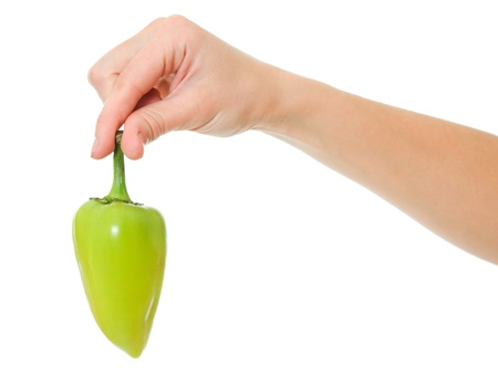 A woman holds in her hand pepper on a white background.の写真素材
