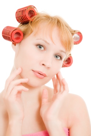 Woman in curlers on a white background.の写真素材