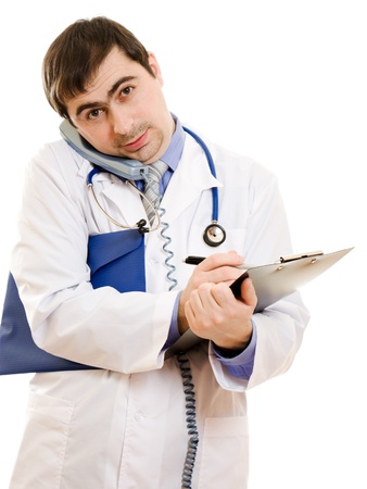 Male doctor talking on the phone and writing on the document plate on a white background.の写真素材